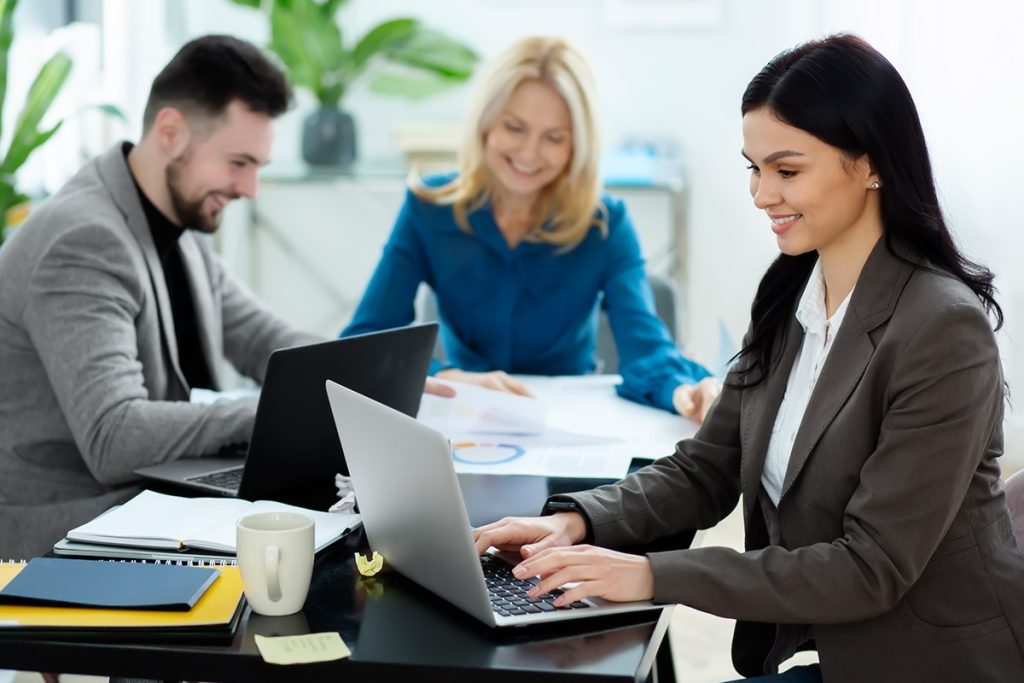 The Accura International team collaborating in the office
